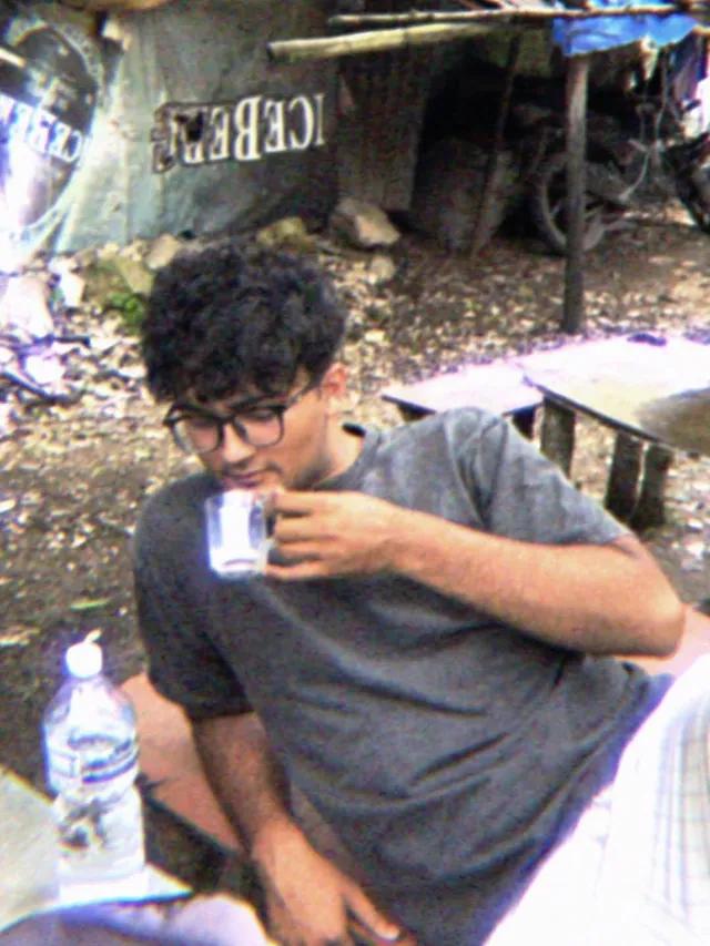 Martin sipping tea at a roadside stall