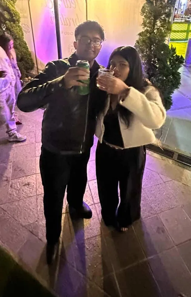 Martin and his big sister raising a toast at a night event